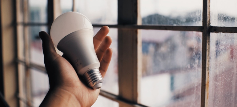 A person holding LED light bulb