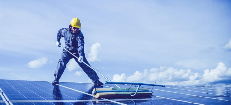 A person cleaning solar panels.