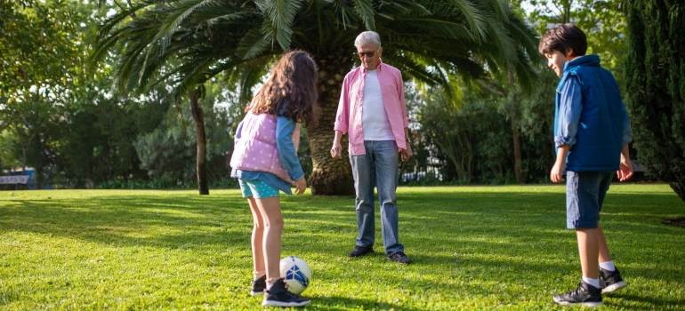 Kids playing ball with an elderly relative.