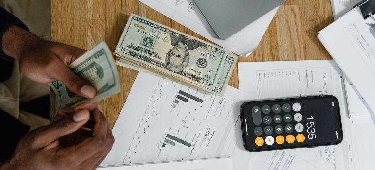 person counting money on a table