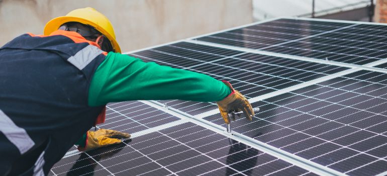 person installing solar panels