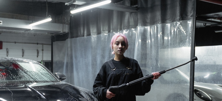 A woman holding a pressure washer