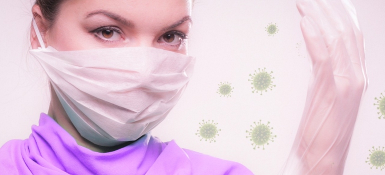 A woman wearing protective mask and gloves.