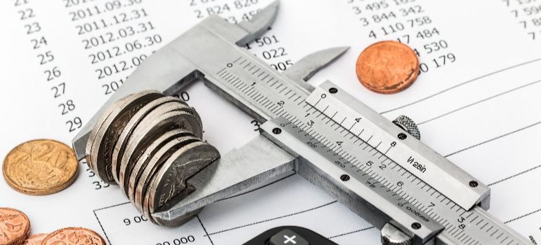 calipers gripping a stack of coins