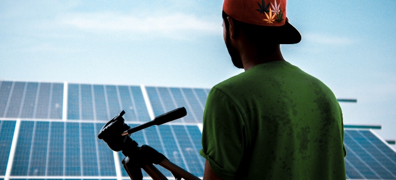 a man in front of solar panels