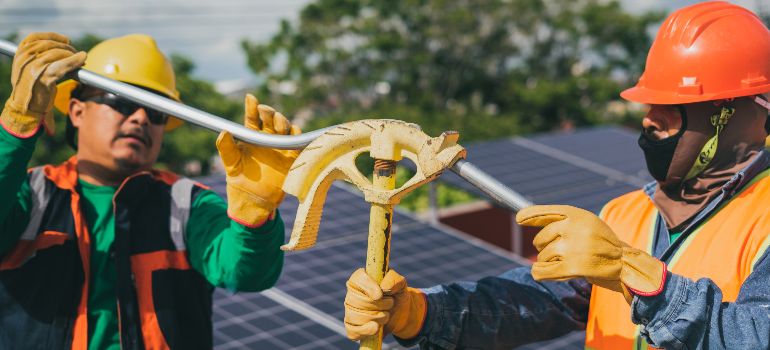 workers installing solar panels