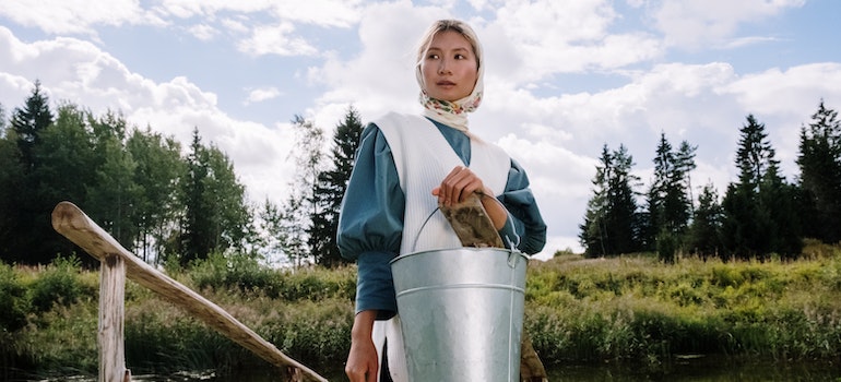 A woman holding a bucket of water