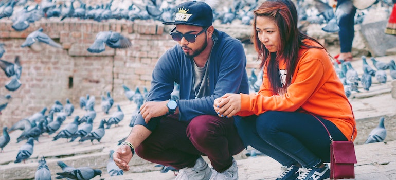 Couple feeding pigeons