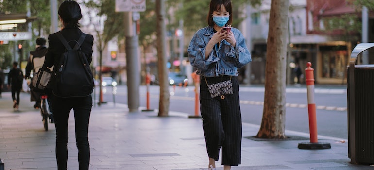 A woman on the street wearing mask