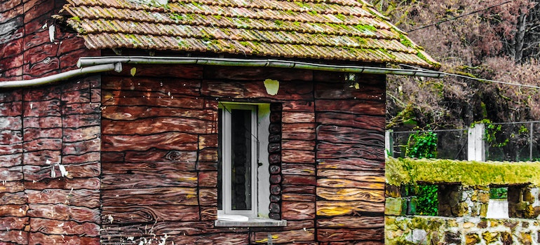 A moss on the old roof as a sign when you need a new tile roof