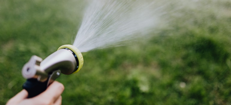 A person holding water hose 