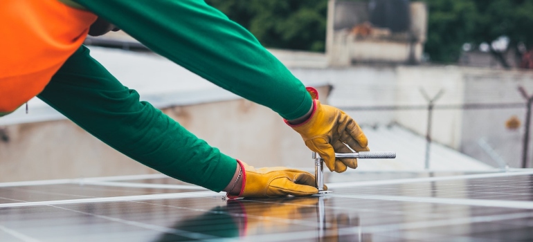 a solar technician installing a solar panel 