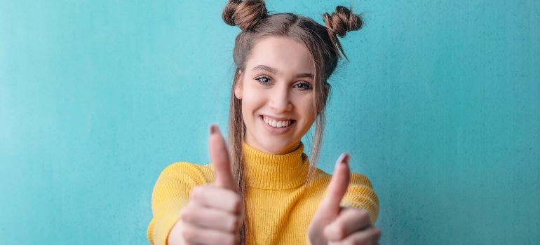 woman smiling because she decided on pigeon trapping vs. pigeon deterrents