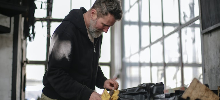 A man organizing tools in the garage