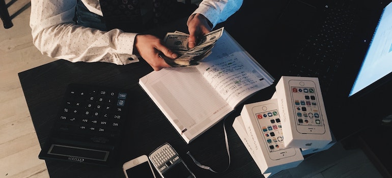 A person counting money while wondering what is the average cost of roof repair in Nevada