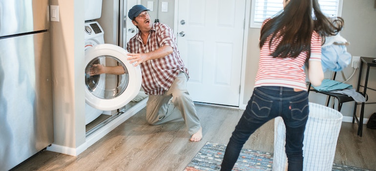 Two people in the laundry room as representation of how to deep-clean every room in your house